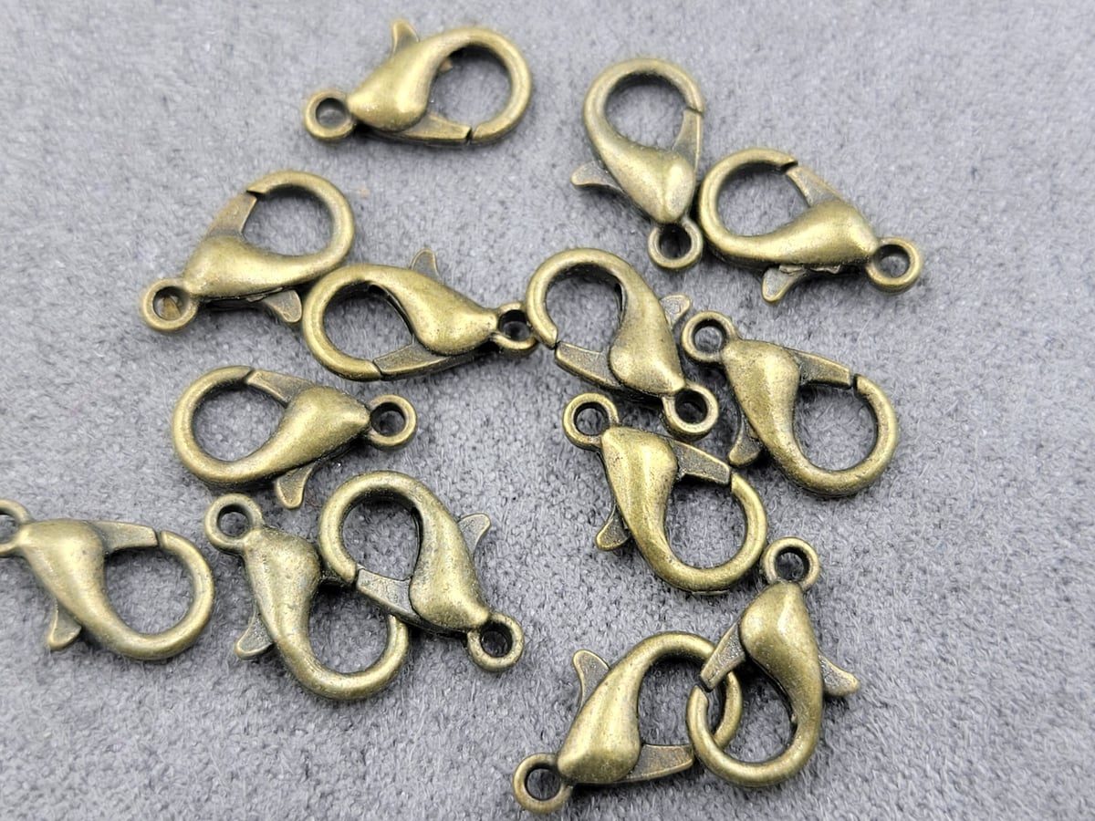 Замки 12 мм (металл) 100 шт колір бронза