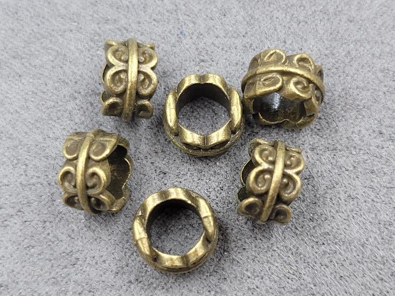 Бусина 5,6*9 мм отв. 5,4 мм 27 шт колір бронза